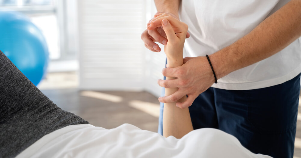 Elbow injury physiotherapist helping patient | elbow injury